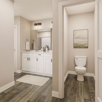 a bathroom with white cabinets and a white toilet